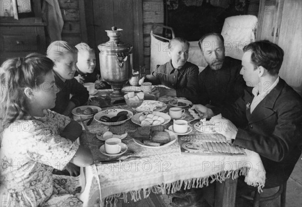 A family at breakfast on the 'pobeda' collective farm, august 1948.