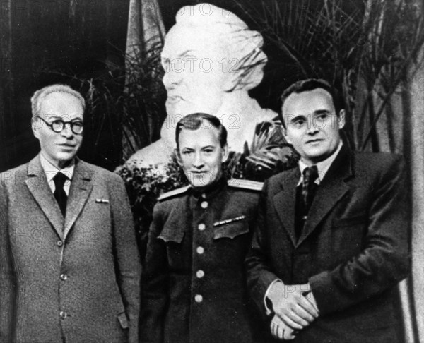 Scientist a, blagonravov and rocket designers mikhail tikhonravov and sergei korolev during celebrations on the occasion of the 90th birthday of konstantin tsiolkovsky, the founder of cosmonautics, a reproduction from 'designer of spaceships' by a, romanov, gospolitizdat publishing house, 1968.