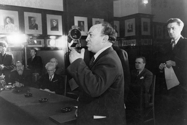 A special meeting of the stalin prize committee held at the moscow art theater where badges and diplomas were being presented to the soviet artists and writers who had been awarded stalin prizes for outstanding works completed in 1945, stalin prize laureate solomon mikhoels is congratulating the prize winners, may 1947.