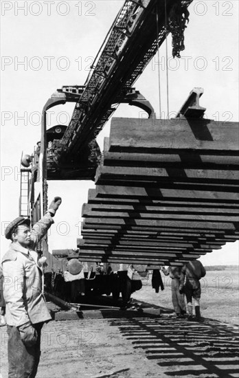 Workers laying track for the 400-mile abakan-taishet railroad through the sayan mountains in siberia, 1960.