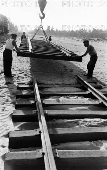 Workers laying track for the 400-mile abakan-taishet railroad through the sayan mountains in siberia, 1960.