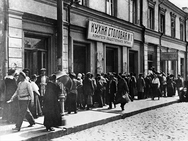 Moscow residents lining up at a canteen of the moscow public catering committee in 1921.