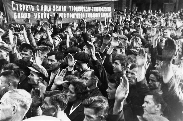 Show trials, workers of the dynamo factory voting for the condemnation of participants in the trotsky-zinoviev plot, 1936, the banner reads: 'wipe the trotsky-zinovievist band of murderers off the face of the earth - thats the judgement of the working people!'.