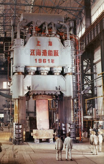 The 1,200 ton hydraulic press at the shanghai heavy plant in china in the early 1960's, it is pictured processing a 55 ton machine part of steel rolling equipment, made and designed in china, the press has a maximum machining capacity of more than 3,000 tons.