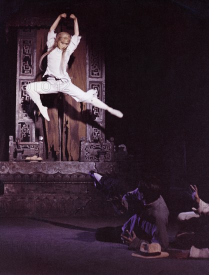 A scene from the revolutionary ballet called 'white haired girl' or 'girl with white hair', 1966, after fleeing from her landlord's home, hsi erh leads a wretched life in a mountain cave, this makes her hair white and arouses in her a still deeper hatred for the class enemy, seething with hatred, she jumps upon the enemy, swearing that she will tear him to pieces.