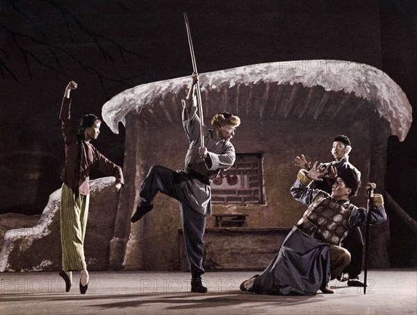 A scene from the revolutionary ballet called 'white haired girl' or 'girl with white hair', 1966, the local despot and traitor huang shih-jen and his running dog break into the house of a poor peasant to compel him to pay an exhorbitantly high inteest rate and forcibly take away his daughter, yang pai-lau, full of defying spllt and class hatred, rises in revolt and strikes the enemy with his shoulder pole.