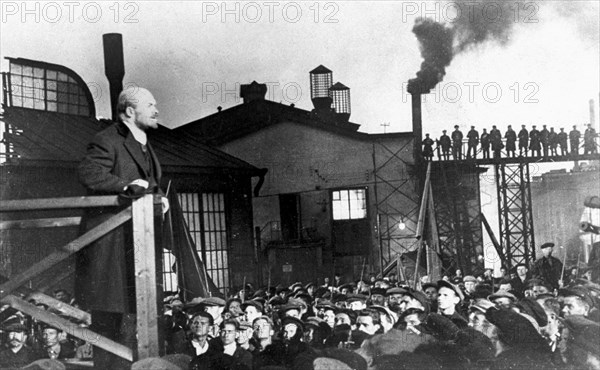 Bolshevik leader vladimir ilyich lenin (l) addressing crowd of factory workers during october revolution.