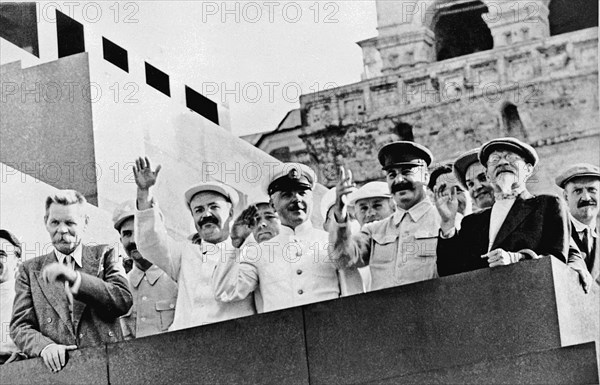 Maxim gorky, vyacheslav molotov, k, voroshilov, joseph stalin, ,mikhail kalinin and nikolai bulganin (left to right) on the platform of the lenin mausoleum during a sports parade in red square, moscow, july 24, 1934.