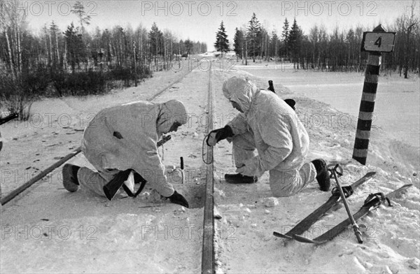 Soviet paratroopers in the enemy's rear, sappers placing mines under railway track, january 1942.
