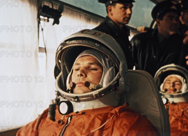 Cosmonaut yuri gagarin on a bus on the way to the launch site of vostok i april 12, 1961, seated behind him is his substitute, gherman titov.