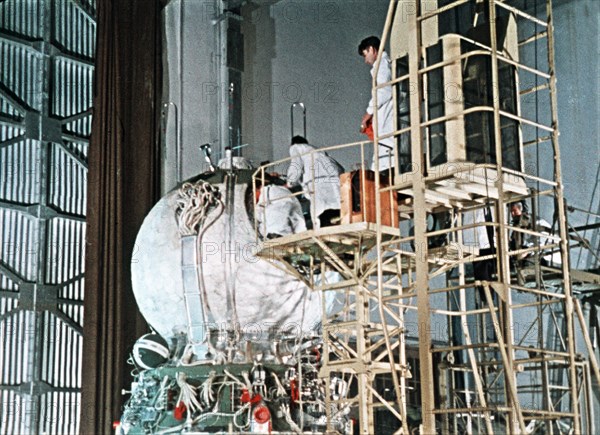 Work being done on the vostok 1 capsule in preparation for gagarin's historic flight, 1961, this is a still from a soviet film about the space program.