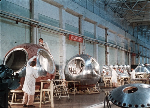 Work being done on the vostok 1 capsule in preparation for gagarin's historic flight, 1961, this is a still from a soviet film about the space program.