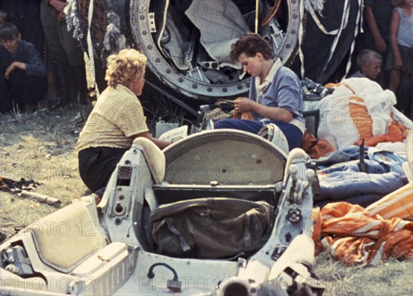 Cosmonaut valentina tereshkova outside of the vostok 6 space capsule after landing, june 1963.