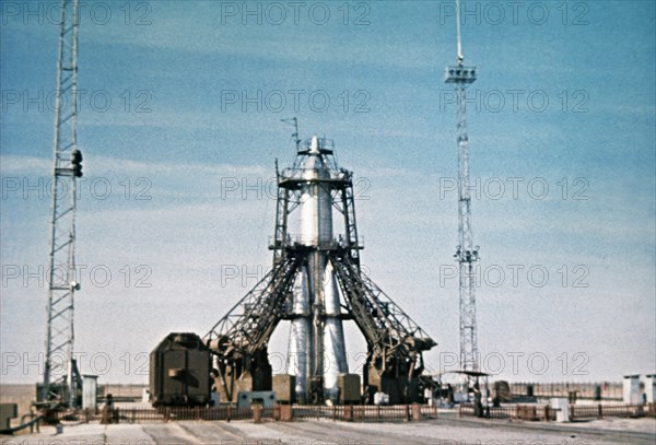 Vostok rocket carrying the sputnik 1 satellite on the launch pad in 1957, this is a still from a soviet film of the launch.