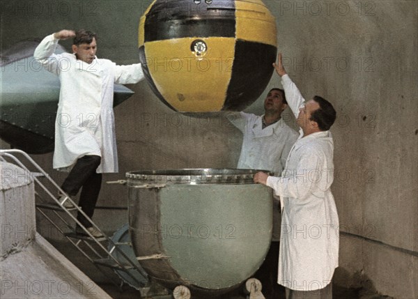 The descent capsule of soviet space probe venera 5 or 6 being lowered into a centrifuge for testing, this is a still from the film 'the storming of venus', produced by e, kuzis at the tsentrnauchfilm central scientific film studio, released on may 17, 1969.