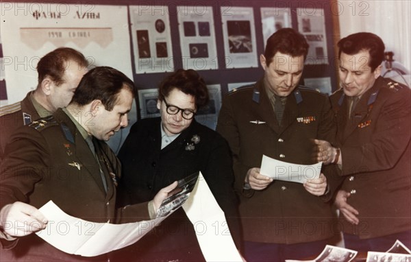Yuri gagarin and other soviet cosmonauts examining the first pictures of the moon taken by the luna 1 space probe (lunik) in 1961.