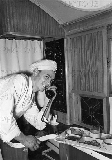 Dima kiryanov taking breakfast orders aboard a tu-104 airliner during a trans-siberian flight, july 1956.