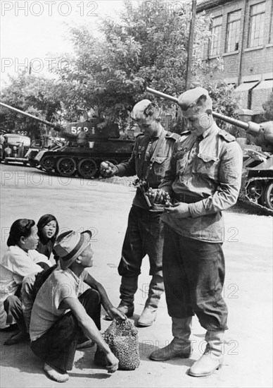 Operation august storm (battle of manchuria), soviet tankists buying grapes from street vendors in port dalny, manchuria, august 1945.