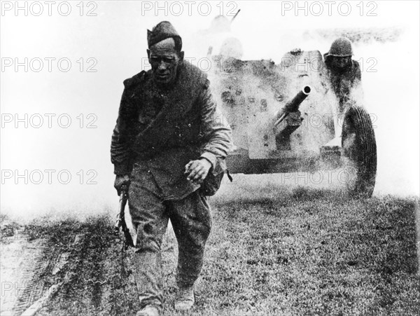 A soviet soldier walking in the battlefield, 1944.