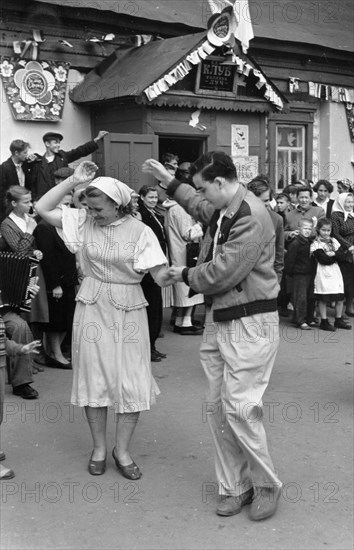 Sixth world festival of youth and students in moscow, july 1957, american participants visiting the luch kolkhoz in the krasnogorsk district near moscow, arby maslin dancing with a young kolkhoznitsa, galya gromova, in front of the kolkhoz club.