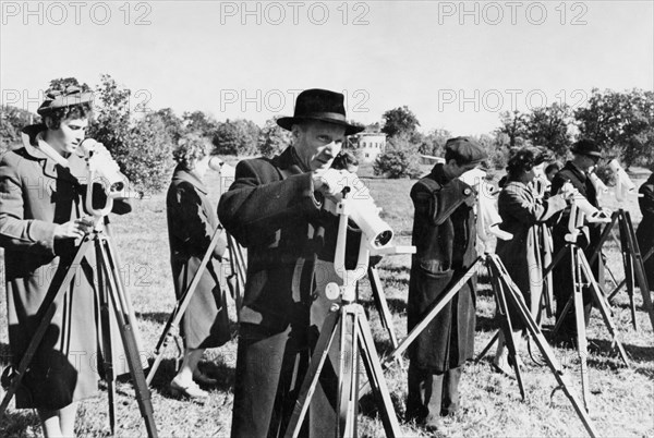 Staff members of the central astronomical observatory of the ukrainian academy of sciences in kiev are preparing for optical observations of the sputnik 1 satellite, 1957.