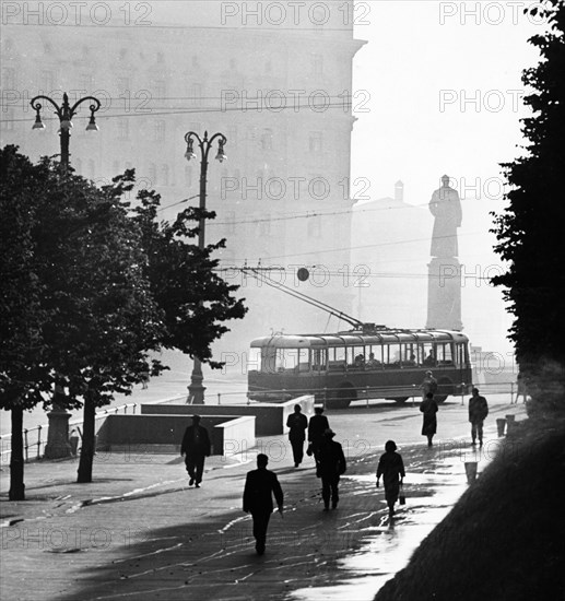 An early morning street scene at dzerzhinsky square in moscow, august 1959, kgb headquarters, lubyanka, is in the background.
