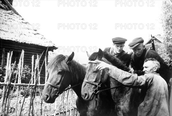 A peasant shows partisans where a nazi patrol made for in leningrad region.