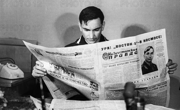 Soviet cosmonaut, lieutenant-colonel valeri bykovsky reading about himself in kazakhstanskaya pravda after his return from the vostok 5 space mission, june 1963.