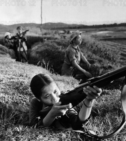 Ready to repulse an american air attack, 18 year old factory worker, dao hong lien, is a member of the self-defense detachment of the creamery in the city of vinh, north vietnam, july 1965.