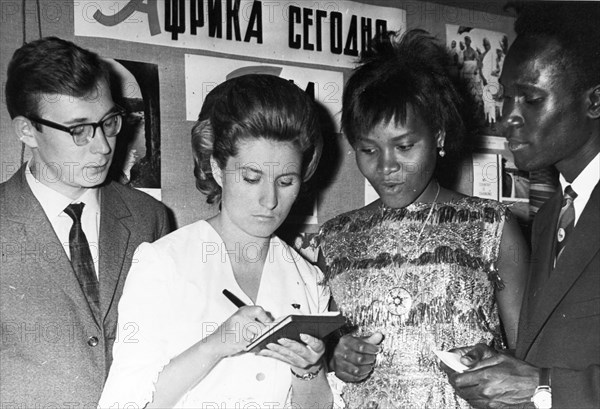 Moscow university student v, okonechnikov and member of the lenin regional komsomol committee, v, nerutcheva with students of the patrice lumumba university (l to r) g, kibuka (uganda) and ali bichio at the ceremony for the opening of the new academic year for the seminar for students 'soviet union - new africa', september 1965.