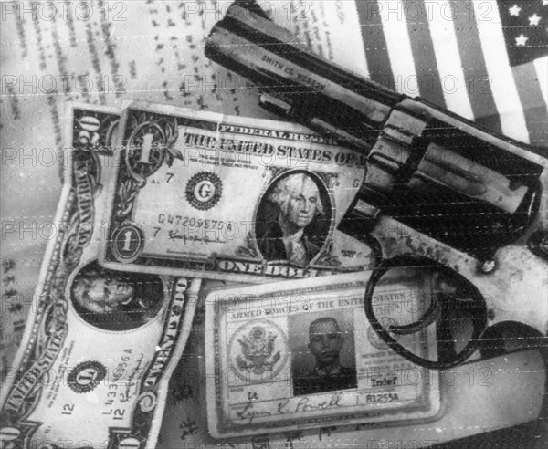 Vietnam war, pistol, money, and identification documents of u,s,a,f, lieutenant lynn k, powell whose plane was shot down by vietnamese anti-aircraft gunners during a raid on hanoi on august 21, 1967, together with his plane, the american air pirate has found his inglorious end in vietnam.