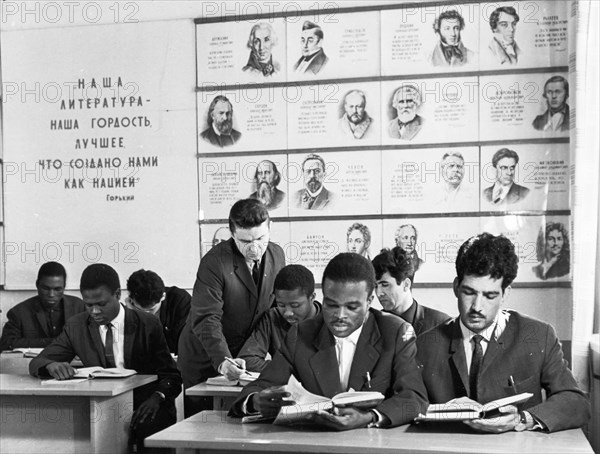 Order of the red banner of labor technical school of the korinsk state farm in the bryansk oblast, may 1969, ivan ivanovich yakushev, a teacher of russian language and literature, instructing a group of foreign students (first row, l to r): ovuar samuel (kenya), jaques pierre eli muculu (congo brazzaville), and abdullah baki gani (afghanistan).