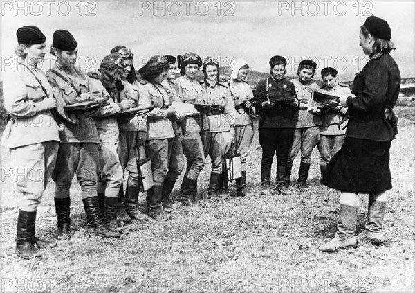 Women pilots of the 46th taman guards night bomber regiment (named by the germans the 'night witches') receiving orders for an up-coming raid, byelorussian front, world war 2, 1944, they flew polikarpov po-2 planes.
