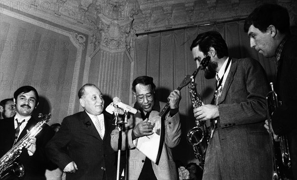 American composer duke ellington playing a russian balalaika that was given to him as a gift, to his right is the soviet composer sigizmund katz, october 13, 1971.