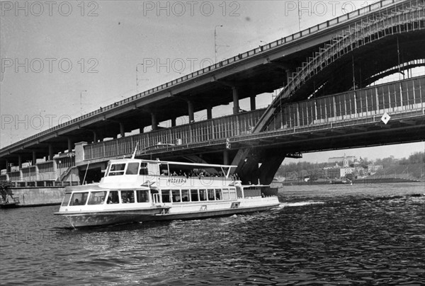 Moscow, ussr may 1972, a motorship on the moskva river passing under the metro bridge at lenin hills.