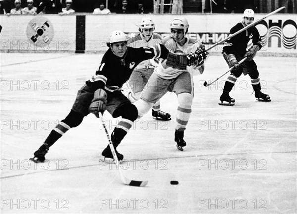 A juniors hockey match between the soviet army team of leningrad and the verdun maple leafs of canada, s, vasilyev (left) fighting for the puck, f, bernard (center) and v, pribylov (right), march 1974.