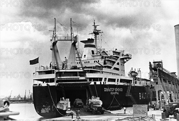 The soviet freighter 'sculptor konenko' unloading trucks and machinery in the port of havana, march 1976.