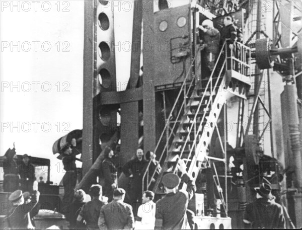 A still from the film 'ten years of the space age ' last minutes before the start of the spaceship 'vostok ' ,yuri gagarin( upstairs) answering the cheering of the starting team.