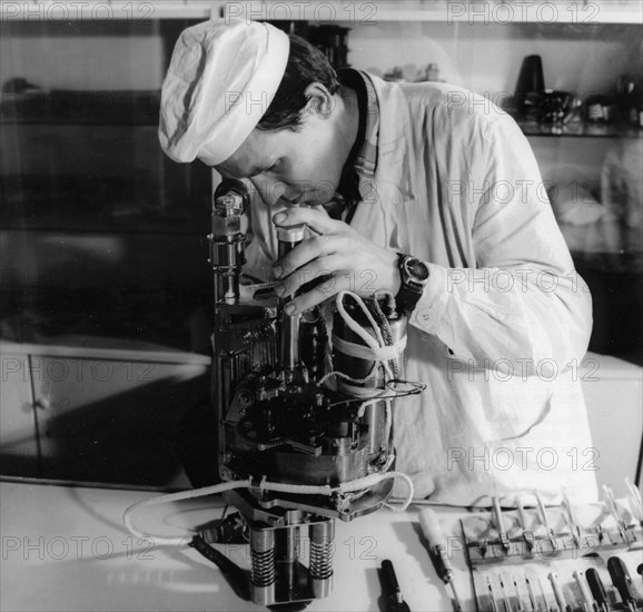 A technician working on the soil drill assembly of the venera 11 and 12 soviet space probes, 1978.