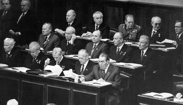 The 6th session of the ussr supreme soviet of the 10th convocation, first row: chernenko (left), brezhnev (right), second row: mikhail gorbachev (center), third row: directly above gorbachev and next to ustinov is romanov, far right is gromyko and andropov is second from the right,november 17, 1981.