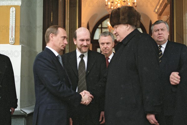 Moscow, russia, outgoing russian president boris yeltsin (r) shaking hands with russian prime minister and acting president vladimir putin (l) as he leaves moscow's kremlin, the seat of russian power,1999.