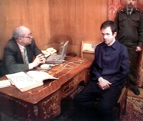 Moscow, russia, march 14, 2000, notorious chechen warlord salman raduyev /r/ started testifying on monday evening on 'episodes' of apartment houses' blasts in moscow last september to investigator of russian prosecutor-general's office valery popov /in pic,/, in the lefortovo investigation prison, raduyev was arrested as a result of a special operation carried out by the federal security service last sunday.