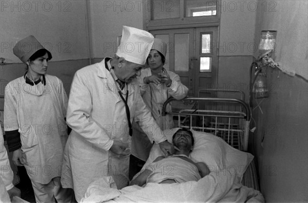 Khushkadam kamardinov, chief infectionist of tajikistan, is pictured during medical examination of one of the typhiod patients at an intensive therapy unit of a dushanbe's hospital on feb, 26th, typhoid fever epidemic has been registered in tajikistan, only in dushanbe over 2500 people were taken into hospital with such diagnosis, the epidemic has already claimed 20 lives, dushanbe, tajikistan, february 26, 1997.