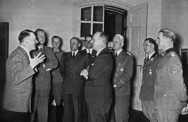 Germany, german foreign minister ulrich friedrich wilhelm joachim von ribbentrop (c) talks with dictator adolf hitler (1st l) at the reich chancellery, berlin, on his arrival to berlin after signing the soviet-german non-aggression pact (the molotov-ribbentrop pact), in 1939, the photograph was on display at an exhibition entitled 'germany's war against the soviet union'.