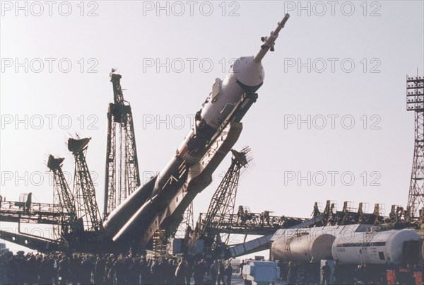 Baikonur, kazakhstan , april 26, 2001, a souyz tm-32 spacecraft with a booster-rocket pictured being erected at a launching site of baikonur cosmodrome on thursday , the launch of a russian crew and the world's first ever space tourist dennis tito, is scheduled on april 28.