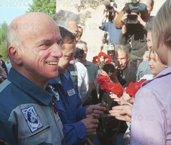 May 6, 2001, american space tourist dennis tito seen being welcomed in the chkalovsky airfield in the moscow region, on sunday, the crew ended an eight-day visiting expedition to the international space station (iss) and returned to the earth at 9:41 a,m, moscow time on sunday, they had completed the main goal of their expedition -- the replacement of the soyuz tm-31, which had worked for the iss since november 2, 2000, with the soyuz tm- 32.