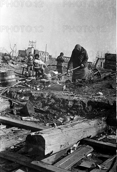 World war 2, stalingrad, ussr, february 1943: stalingrad residents clearing debris on the sites of their ruined homes after the defeat of the nazis.