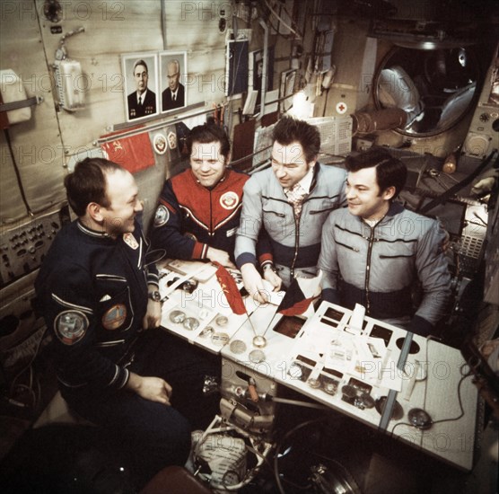 The crews of soyuz 26 and soyuz 28 missions (vladimir remek, alexei gubarev, oleg makarov and georgi grechko) open mail aboard the salyut 6 space station, march 1978.