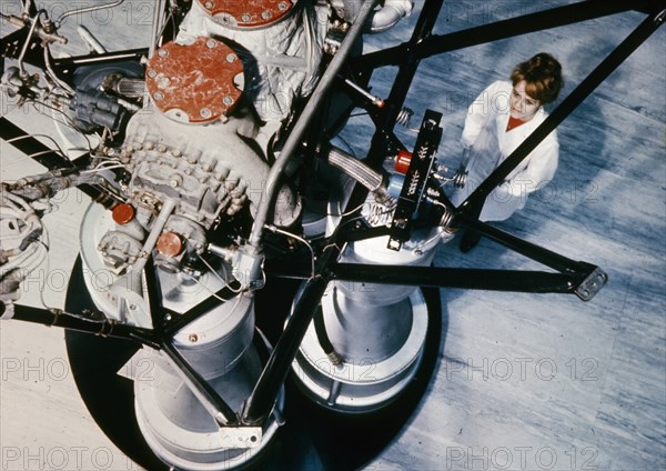 Soviet technician inspecting part of an  rd-? rocket engine installed in the second stage of cosmos carrier rockets, 1969.