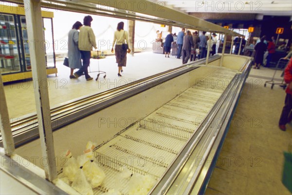 Empty meat cases at grocery store n4 in moscow, restrictions on the sale of food and consumer goods to non-muscovites, imposed by the capital's new authorities, hasn't done much to increase the selection, ussr, may 1990.